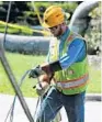  ?? JOE BURBANK/STAFF PHOTO B1 ?? A Duke Energy contractor coils downed power lines. More Hurricane Irma coverage,