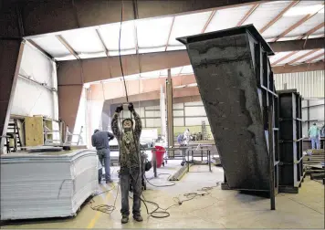  ?? PHOTOS BY JOYCE MARSHALL / FORT WORTH STAR-TELEGRAM ?? Employees work on a bomb shelter recently at Rising S Co. in a football-field-sized warehouse in Murchison, Texas, an hour’s drive southeast of Dallas.