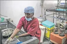  ?? [DHIRAJ SINGH/BLOOMBERG] ?? A worker washes surgical equipment at Sudar Hospital in Chennai, India. Piped water has dried up at many of the city’s hospitals, which have become dependent on deliveries from water trucks during the nation’s drought.