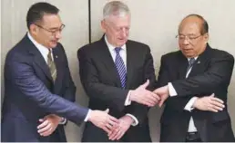  ??  ?? Mattis joins hands with Hishammudd­in (left) and Myanmar National Security Adviser U Thaung Tun at the summit.