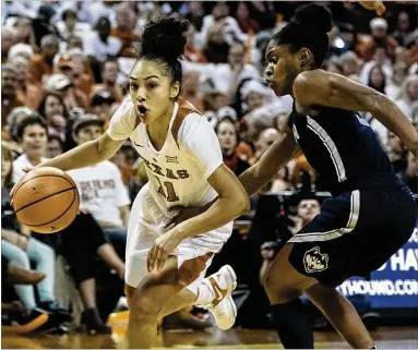  ?? RODOLFO GONZALEZ / AUSTIN AMERICAN-STATESMAN ?? Texas’ Brooke McCarty (11), part of one of the nation’s top backcourts, helped keep it close Monday vs. UConn in UT’s 75-71 loss. Some misses from the free throw line and a late blown layup let the upset slip away.