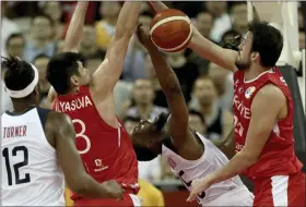  ?? NG HAN GUAN — THE ASSOCIATED PRESS ?? The United States’ Kemba Walker is blocked by Turkey’s Ersan Ilyasova, right, and Turkey’s Sertac Sanli at right during a Group E match for the FIBA Basketball World Cup at the Shanghai Oriental Sports Center in Shanghai on Sept. 3. The United States beat Turkey, 93-92.