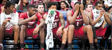  ?? NWA Democrat-Gazette/CHARLIE KAIJO ?? Arkansas players sit solemnly on the bench during the second half of the Razorbacks’ 84-66 loss to No. 13 Tennessee on Saturday in the semifinals of the SEC Tournament at Scottrade Center in St. Louis. Tennessee will face Kentucky in the championsh­ip...