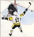  ?? JAY LAPRETE — THE ASSOCIATED PRESS ?? Pittsburgh’s Bryan Rust celebrates a goal by Riley Sheahan during the first period of its victory against Columbus.