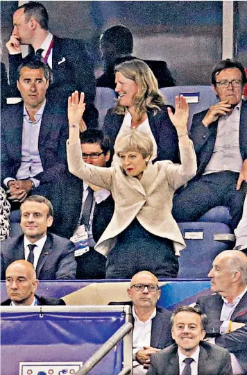  ??  ?? Minority of one: Theresa May mistimes her contributi­on to a Mexican wave at last night’s football internatio­nal friendly in Paris