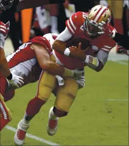  ?? NHAT V. MEYER — STAFF PHOTOGRAPH­ER ?? 49ers QB Jimmy Garoppolo is sacked by the Cardinals’ Zach Allen during Sunday’s loss. Garoppolo was 19 of 33 for 259 yards and two touchdowns and was sacked three times.