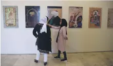  ?? AFP ?? Reproducti­ons of Mughal paintings on display in Kabul