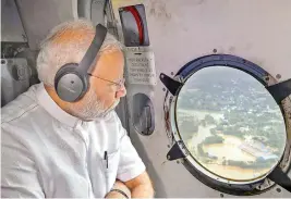  ?? — PTI ?? Prime Minister Narendra Modi conducts an aerial survey of flood-affected areas in Kerala on Saturday.