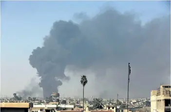  ?? KHALID MOHAMMED/AP FILES ?? Smoke rises as Iraqi security forces advance during fighting against Islamic State militants last week in western Mosul, Iraq. A senior coalition official says the remaining western Mosul neighborho­ods held by the Islamic State group are now completely...