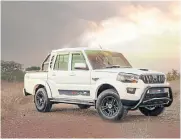  ??  ?? Mahindra joins the blacked-out bakkie trend with black off-road alloy wheels, a dark nudge bar and a dark roll bar.