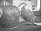  ?? THOMAS SAMSON/GETTY-AFP ?? A breastplat­e and ceremonial helmet stolen from the Louvre 38 years ago have been found.