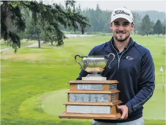  ??  ?? Calgary’s Brett Hogan holds up the trophy after winning the Sun Life Financial Alberta Men’s Amateur Championsh­ip with a spectacula­r birdie on the second hole of a playoff against Max Sekulic.