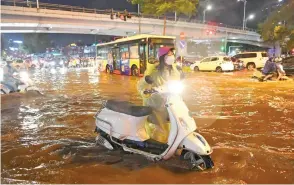  ?? ?? Nhiều tuyến phố ở Hà Nội ngập sâu, xe cộ bì bõm sau trận mưa lớn. Ảnh | THÀNH ĐẠT