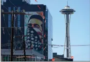 ?? (File Photo/AP/Ted S. Warren) ?? A painting by Shepard Fairey, based on a photo taken by Ted Soqui during a Black Lives Matter protest, is projected onto a building Sept. 2 near the Space Needle in Seattle.