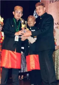  ??  ?? Mohamad Nazim (left) accept his awards from Dr Toyad, witnessed by PMS chairman Mohamad Anis Ili (centre).