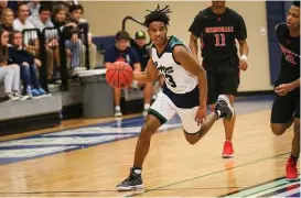  ?? Michael Minasi / Houston Chronicle ?? College Park’s Cameron Noel (13) drives downcourt during the high school boys basketball game against Goose Creek Memorial on Friday, Dec. 15, 2017, at College Park High School.