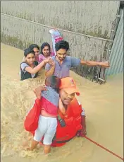  ?? PTI ?? A National Disaster Response Force personnel rescues people from Sonitpur district of Assam on Sunday.
