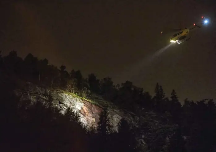  ??  ?? LØVSTAKKEN: Et helikopter lyser opp fjellsiden, hvor raset startet.