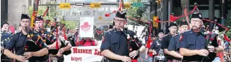  ??  ?? Members of the Calgary Firefighte­rs Associatio­n make their way along the parade route.