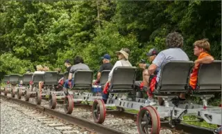  ??  ?? Passengers check out the scenic view during their railbiking excursion.