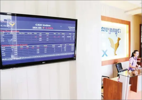  ?? HENG CHIVOAN ?? A monitor displays stock informatio­n next to the reception of the Cambodia Securities Exchange last year.