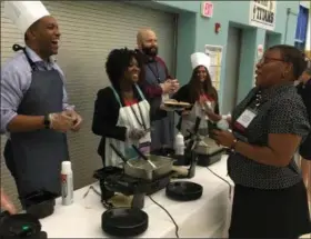  ?? RICHARD PAYERCHIN — THE MORNING JOURNAL ?? Frank Jacinto Elementary School Turnaround Principal Paula Baldwin speaks to Lorain City Schools CEO David Hardy Jr. at the waffle buffet during the opening session of the eightday School Leader Summit, which began June 13. The sessions are at Lorain’s General Johnnie Wilson Middle School. Also pictured are Chief People Officer Jacquie Younker, Chief Strategy and Innovation Officer Joshua Hill and Chief of Staff Elena Gonzalez.