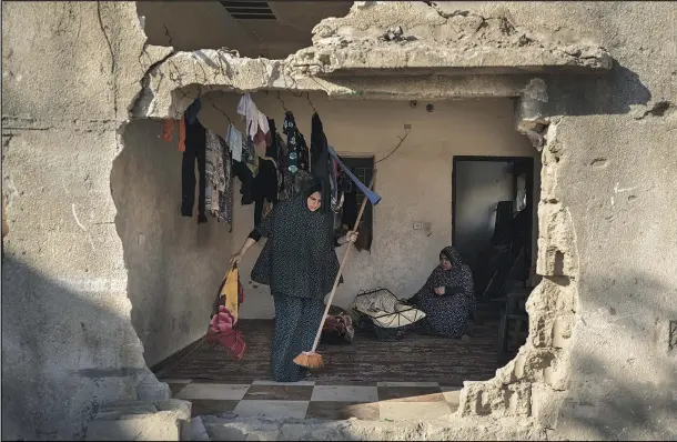  ?? (AP/Felipe Dana) ?? A resident of Al-Baali Street cleans a room June 18 inside her home, heavily damaged by airstrikes in Beit Hanoun, northern Gaza Strip.