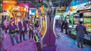  ?? L.E. Baskow Las Vegas Review-journal file @Left_eye_images ?? Attendees learn about the newest slot within the Light & Wonder Inc. display area during Global Gaming Expo 2021 at The Venetian expo center in October.