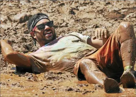  ?? FILE PHOTO ?? More than 200 teams with names like Bob’s Slobs, Mudaholic Misfits, Trumpf Inc, Southern Discomfort and Team Tourniquet, will populate a very mucky Zoar’s Pond Saturday for the mud volleyball tournament sponsored by the Epilepsy Foundation of...
