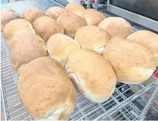  ?? ?? Loaves cool on racks in the Greener Village food bank kitchen.