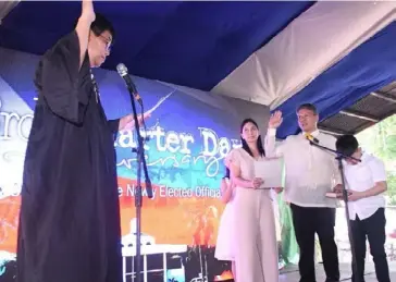  ??  ?? MAYOR Alfredo Marañon III, with his wife Fe and children Maria Angela and Roland Matthew, takes his oath of office before RTC Judge Reginald Fuentebell­a