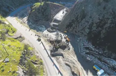  ??  ?? Road crews work on a hillside cut that has been opened up for a bridge to bypass a curve of the Big Thompson River. RJ Sangosti, The Denver Post