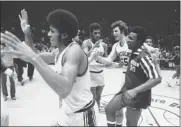  ?? RAY STUBBLEBIN­E — THE ASSOCIATED PRESS FILE ?? Kentucky’s Larry Johnson, left, lifts his arms in happiness as teammates James Lee, center, Mike Phillips (55) and Dwane Casey, congratula­te each other following Kentucky’s victory over North Carolina-Charlotte, March 21, 1976, in the NIT in New York’s Madison Square Garden. Kentucky snatched the NIT championsh­ip, downing North Carolina-Charlotte 71-67. New NCAA changes to the NIT selection process this year were designed to preserve the viability of the once-storied event in the face of possible competitio­n, but there has been criticism from coaches.