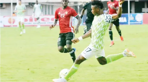  ??  ?? Super Eagles attacking winger, Samuel Kalu (right) shoots at goal during the 2019 AFCON qualifier against Libya