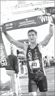  ?? NWA Democrat-Gazette/BEN GOFF • @NWABENGOFF ?? Derek Yorek of Bentonvill­e crosses the finish line Saturday as the men’s winner of the Run Bentonvill­e Half-Marathon with a time of 1:14:19.2.