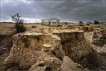  ?? Photograph­s by Marcus Yam Los Angeles Times ?? IN THE LAST three decades, the Dead Sea level has fallen almost 100 feet, and the rate of loss — 3 to 5 feet a year — is accelerati­ng. The sinkholes created, such as these in Ghor Haditha, Jordan, number in the thousands.