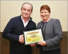  ??  ?? Eileen Gyves (Treasurer) presenting a Mallow Tidy Towns Certificat­e of Appreciati­on to Mattie Taylor of Food Capers.