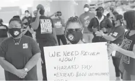  ?? JOERAEDLE/GETTY ?? Toni Hernandez joins with unemployed airportwor­kers and other supporters to ask thatDelta Airlines contractor, Eulen America hire back theirunemp­loyed Fort Lauderdale-Hollywood Internatio­nal Airportwor­kers onAugust 13, in Fort Lauderdale, Florida.