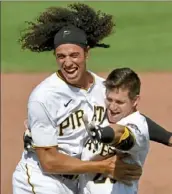  ?? Matt Freed/Post-Gazette ?? Pinch-runner Cole Tucker, left, celebrates with Kevin Newman Thursday after Newman drove in the tying and winning runs with a single in the bottom of the ninth inning to beat the Twins at PNC Park.