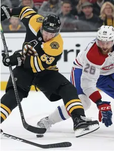  ??  ?? NIFTY MOVE: Bruins forward Brad Marchand shows off his skill as Montreal Canadiens defenseman Jeff Petry watches on Wednesday night.