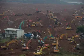  ?? — AFP ?? Rescue workers look for survivors after a landslide hit an industrial park in Shenzhen, south China’s Guangdong province, on Monday.