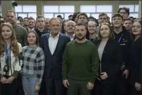  ?? EFREM LUKATSKY — THE ASSOCIATED PRESS ?? Ukrainian President Volodymyr Zelenskyy and Poland’s Prime Minister Donald Tusk pose for photos with Ukrainian students after their meeting in Kyiv, Ukraine, on Monday.