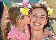  ?? PHOTO: BEV LACEY ?? Danielle Labinsky and Milla Collins, 7, line up for henna tattoos at the Ergon Food and Wine Festival.