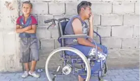  ??  ?? KOSOVO: This file photo shows Jetullah Veliu, 16-years-old, sitting on a wheelchair along a street in the Roma neighborho­od in the town of Mitrovica. — AFP