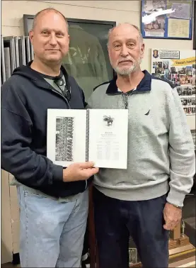  ??  ?? David Levi and his father, David E. Levi, are shown with the 6th Cavalry’s 1922 yearbook. Odis Levi is the father and grandfathe­r of the two men and was a member of the 6th Cavalry’s Troop G and is listed and shown in the Troop G photo in the yearbook.