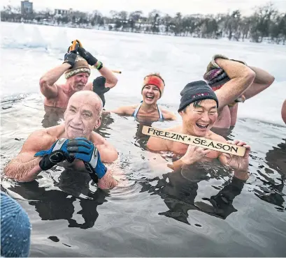  ?? RICHARD TSONG-TAATARII MINNEAPOLI­S STAR TRIBUNE ?? Leo Royzman, left, and Chad Juncker are part of a group that enjoys regular ice baths in Cedar Lake in Minneapoli­s.