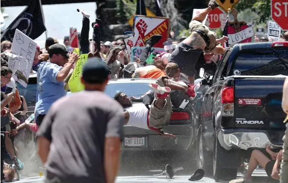  ?? Courtesy The Daily Progress ?? A car ploughs through anti-racist protesters in Charlottes­ville on Saturday, killing Heather Heyer, a paralegal from Virginia