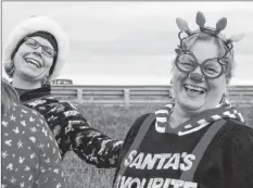  ?? CAROLE MORRIS-UNDERHILL ?? Heather Bennett, left, teases Elizabeth Manuel as they prepare to hit the trail for the Fitness Junkies’ annual Ugly Christmas Pyjama Run, which was held in Windsor on Dec. 1.