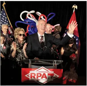  ?? Arkansas Democrat-Gazette/STATON BREIDENTHA­L ?? Gov. Asa Hutchinson, joined by first lady Susan Hutchinson and other family members, speaks Tuesday night at a watch party at the Embassy Suites in Little Rock.