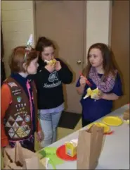  ?? SUBMITTED PHOTO ?? Kelsea Gibson, Jocelyn Strachko and Averi Maurer, all members of Brownie Troop #1759, trying out some new foods.